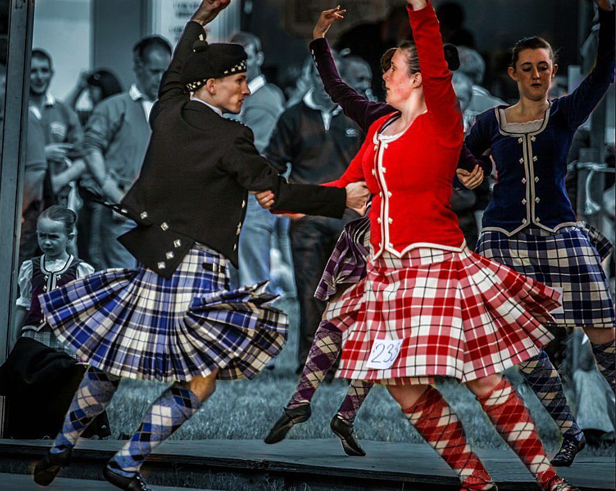 The pair dancing the Scottish dance in a kilt The pair dancing the Scottish dance in a kilt