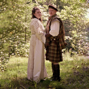 A man and woman in traditional clothing standing in a forest, wearing the Heavy Weight 16oz Premium Wool Ancient Kilts. A man and woman in traditional clothing standing in a forest, wearing the Heavy Weight 16oz Premium Wool Ancient Kilts.