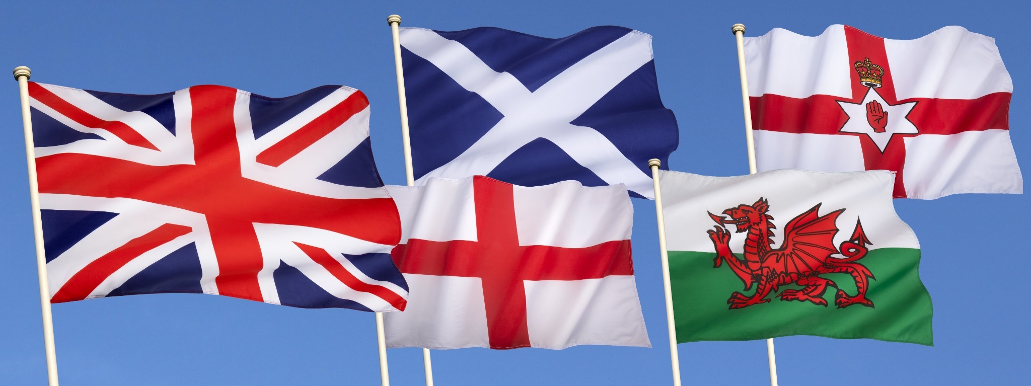 The flags of Great Britaina nd Ireland including the Welsh Drago, St. Andrew's Cross, Ulster Flag, the Union Jack and the flag of Northern Ireland.