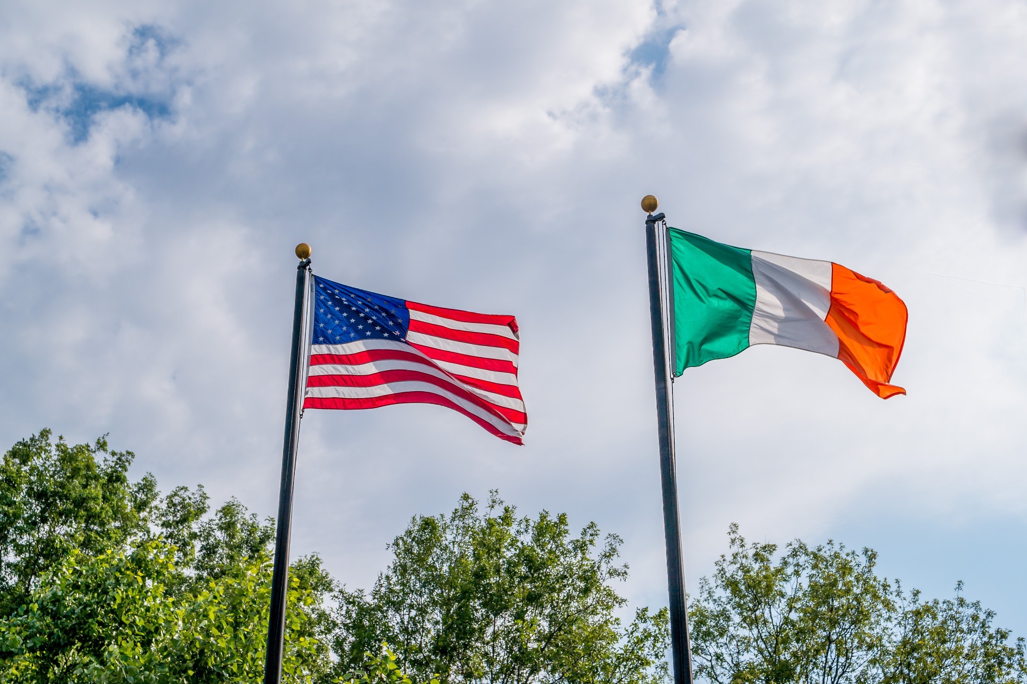 The American flag and Irish flag flying next to each other to celebrate Irish-American heritage.
