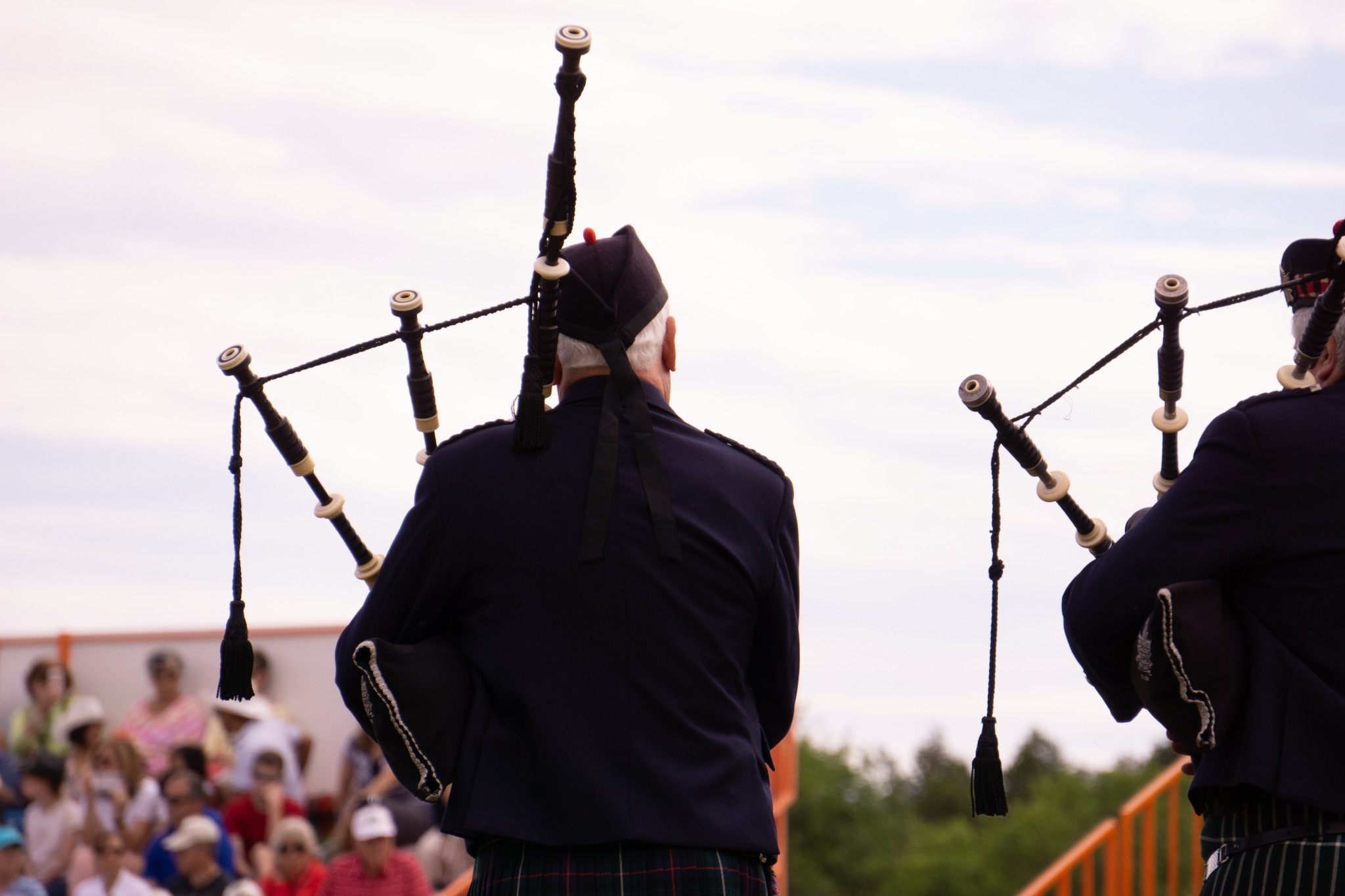 Gentlemen playing bagpipes at a modern event.