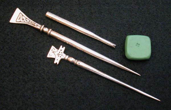 A reproduction brass stylus and poker
