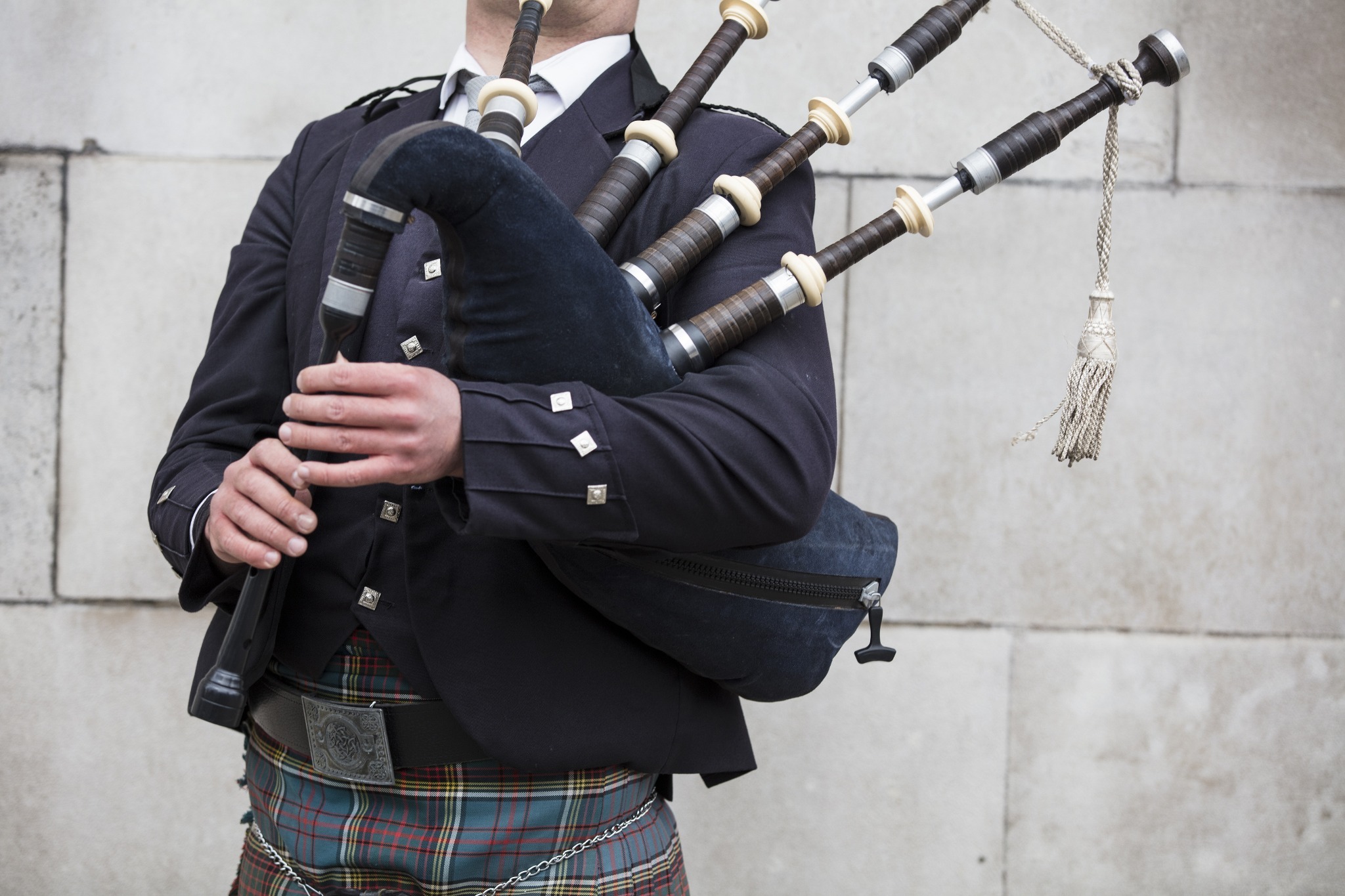 irish bagpiper holding bagpipes