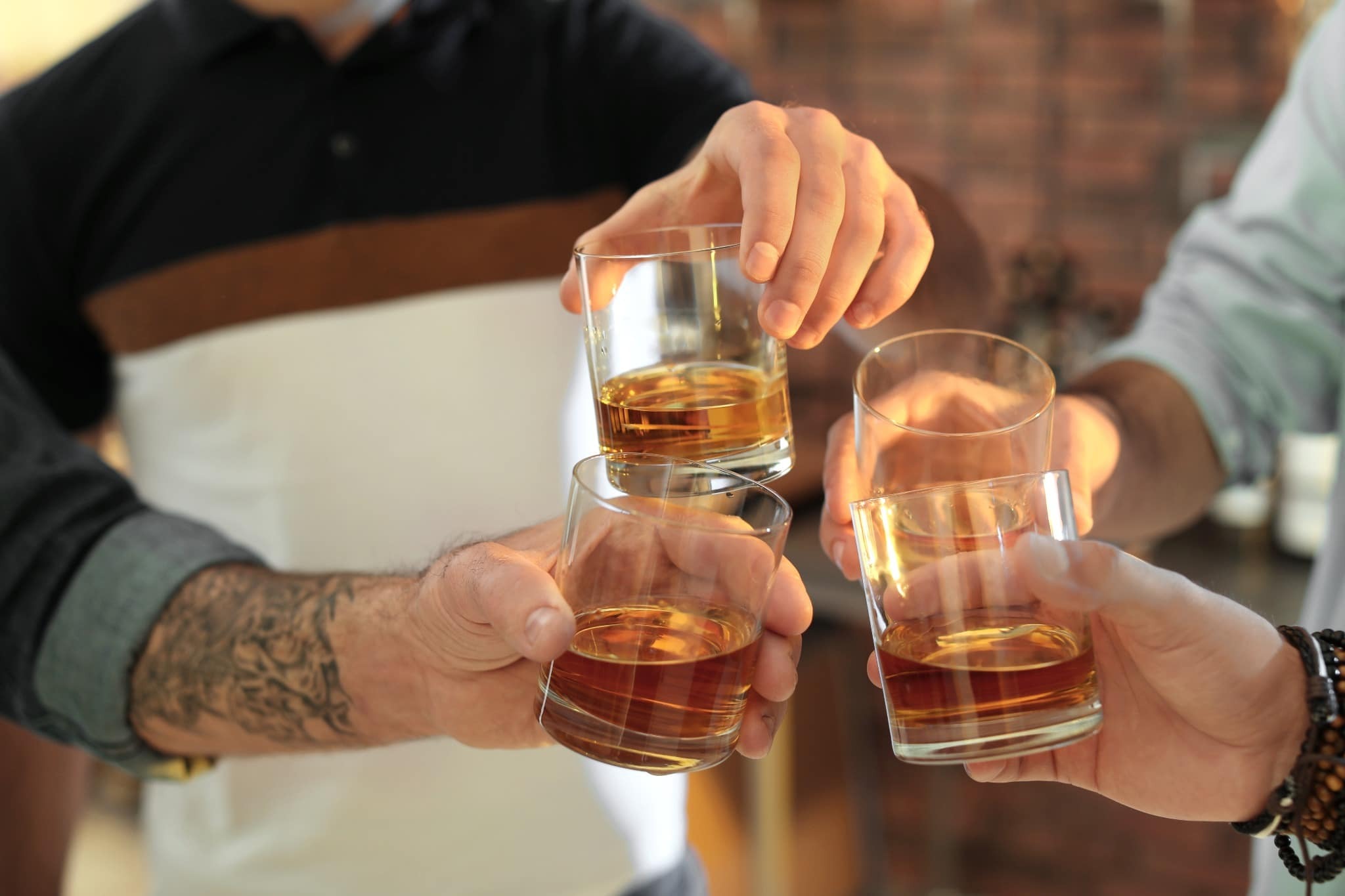 A group of men toasting glasses of whisky at a Burns Night celebration