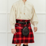 A person wearing a traditional Scottish outfit, consisting of a white blouse, a red tartan kilt, the Celtic Knot Utility Belt and Buckle, and a sporran.