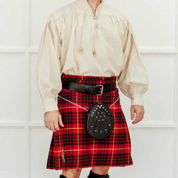 A person wearing a traditional Scottish outfit, consisting of a white blouse, a red tartan kilt, the Celtic Knot Utility Belt and Buckle, and a sporran.