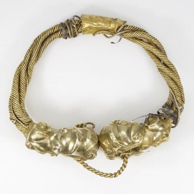 A Celtic torc adorned with a pair of gold horns.