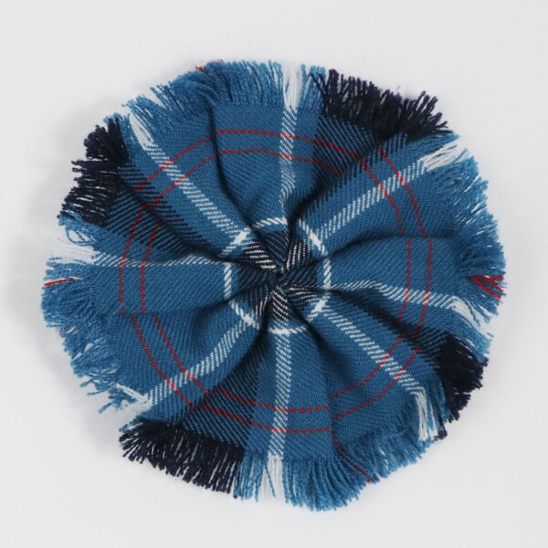 A U.S. Navy Wool-Blend Tartan Rosette on a white surface should be replaced with the product name: U.S. Navy Wool-Blend Tartan Rosette.