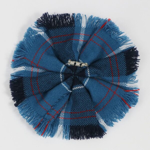 A U.S. Navy Wool-Blend Tartan Rosette brooch on a white surface, named U.S. Navy Wool-Blend Tartan Rosette.