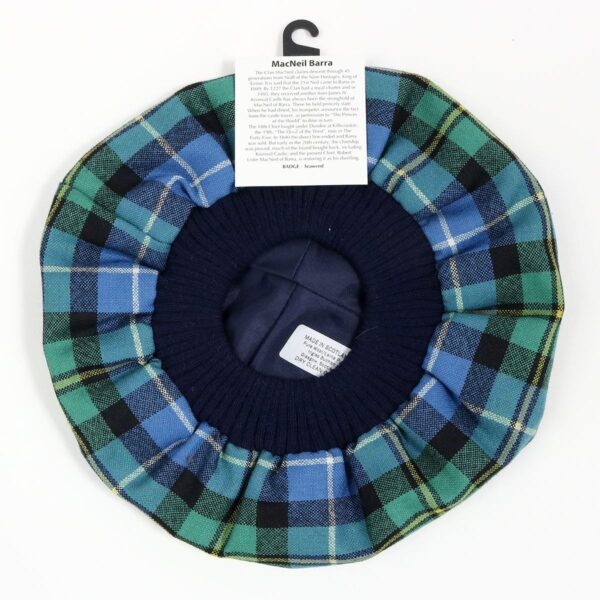 A blue and green plaid MacNeil of Barra Ancient Spring Weight Tartan Tam-sold hat with a tag on it.