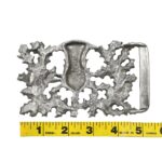 A Don McKee Thistle Kilt Belt Buckle with a measuring tape.