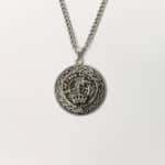 MacQuarrie clan crest necklace with skull and crossbones design on a white background.