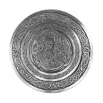 A silver plate with a Celtic Hounds Pewter Kilt Belt Buckle design on it.