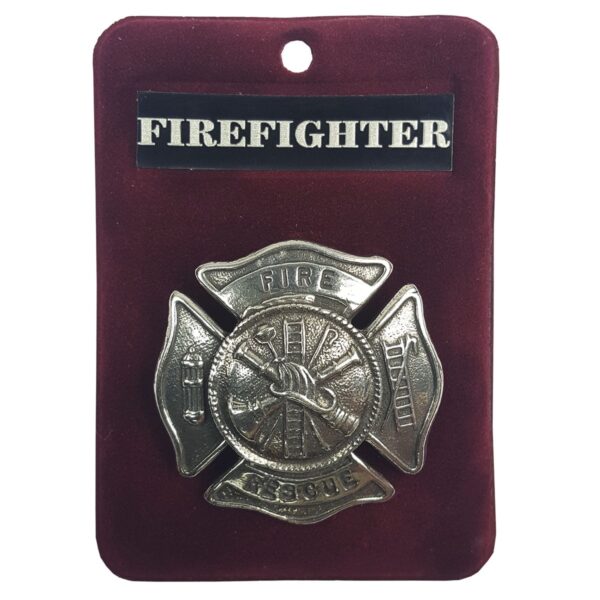 A Fire Rescue Firefighter Cap Badge/Brooch on a red background.