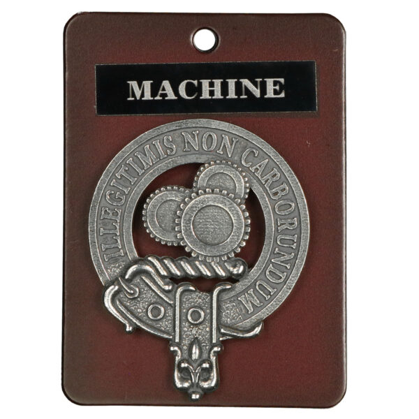 A Machine Gears Steampunk cap badge/brooch with the word "Machine" on it.