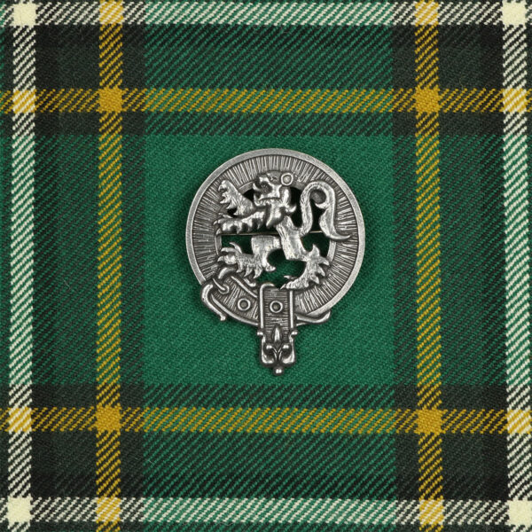 A Scottish kilt badge featuring a Rampant Lion Cap Badge/Brooch on a green and yellow tartan, with a cap badge.