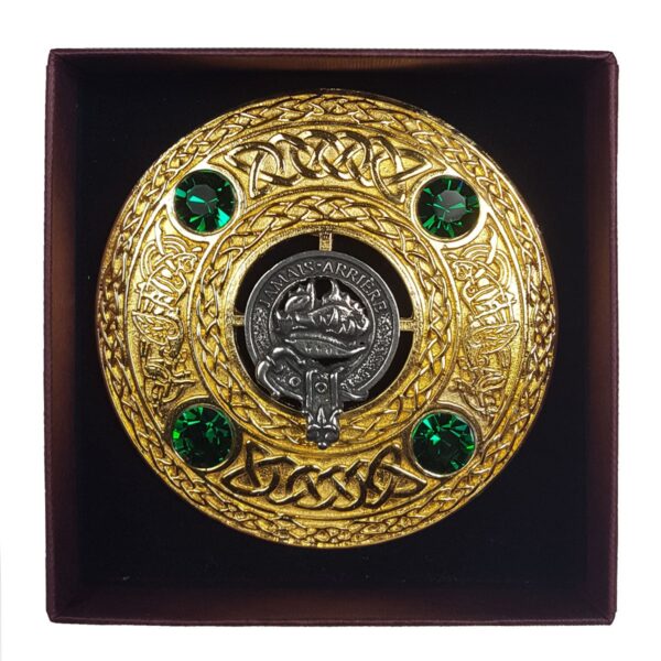 A Clan Crest Plaid Brooch featuring a Clan Crest Plaid Brooch circular object with green gems in a box.