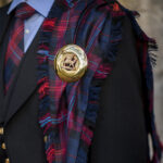 A Welsh Tartan Medium Weight Premium Wool Fly Plaid is on a mannequin.