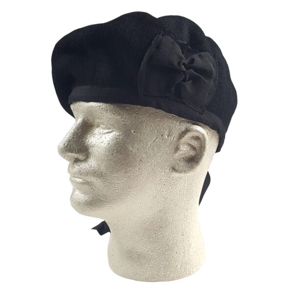 A mannequin wearing a black beret and a Felted Wool Balmoral.