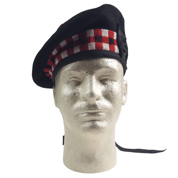 A mannequin wearing a black and red tartan felted wool Balmoral beret.
