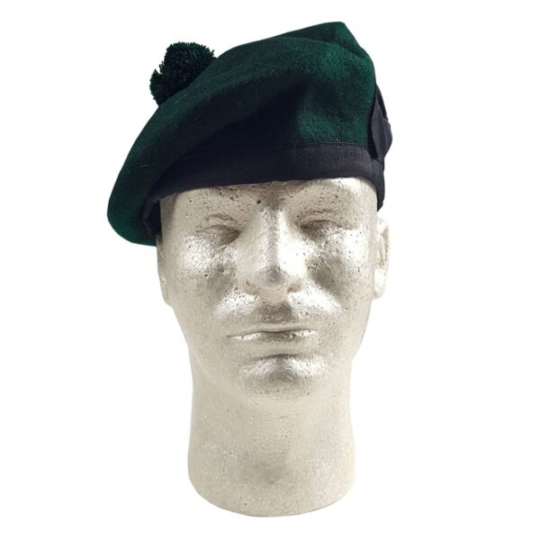 A mannequin wearing a green beret, also known as a Felted Wool Balmoral.