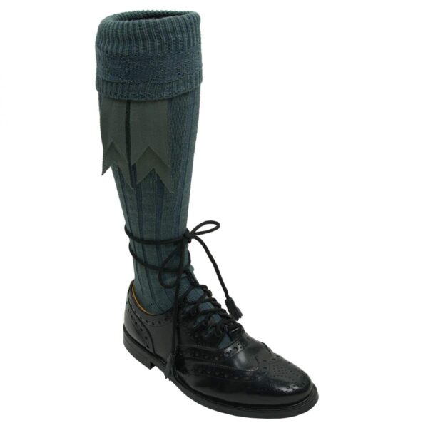 A pair of knee high boots with a Wool Flashes - Lochcarron of Scotland - Hook Closure on them.