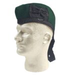 A mannequin wearing a green cap with a black Felted Wool Glengarry bow.