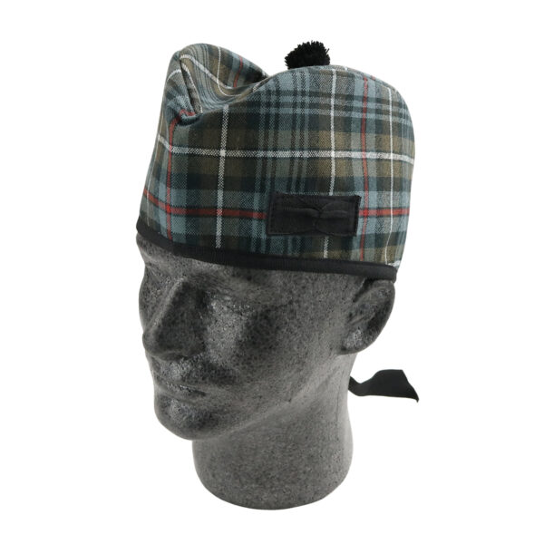 A mannequin wearing a plaid hat, the MacKenzie Weathered Tartan Glengarry XXL.