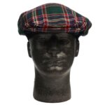 A mannequin wearing a green and red tartan hat.