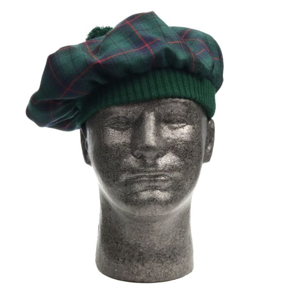A mannequin wearing a green tartan beret.