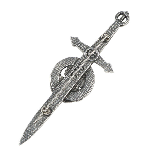 A metal sword with an Irish Shamrock Kilt Pin circle on top of it.