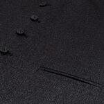 A close up of a black suit with buttons and a Tweed 5 Button Vest.