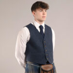 A man in a kilt wearing a blue Tweed 5 Button Vest.