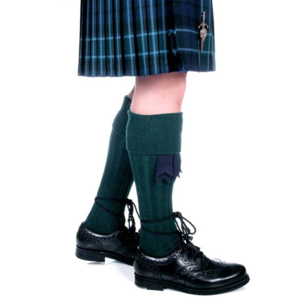 A person wearing a green kilt and Quality Wool Blend Kilt Hose made of quality wool blend.