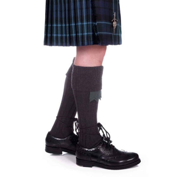 A man wearing the Quality Wool Blend Kilt Hose and black shoes.