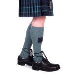 A woman wearing Quality Wool Blend Kilt Hose and a kilt.