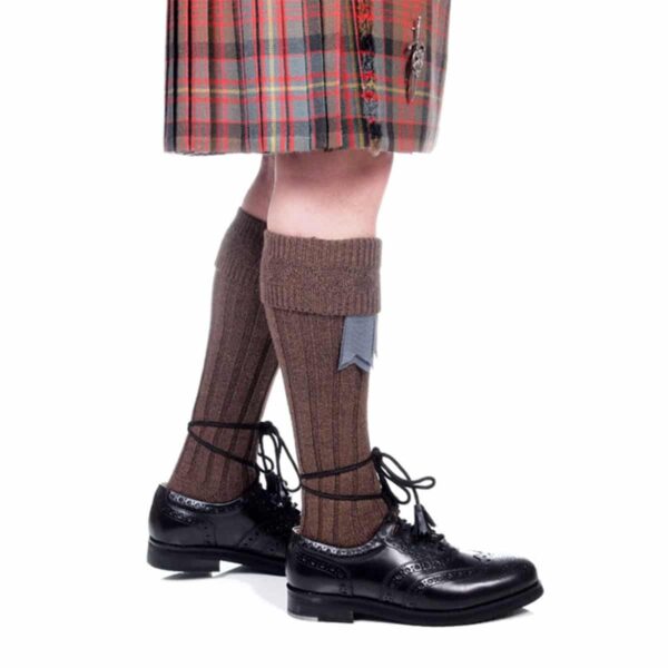 A man wearing a kilt and black shoes, paired with "Quality Wool Blend Kilt Hose".