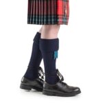 A Piper Kilt Hose dressed in a kilt and Piper Kilt Hose.