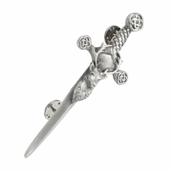 A silver sword with a celtic design and a Stag's Head Kilt Pin.