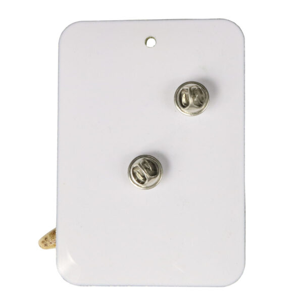 A white plate with two buttons on it, adorned with an Antler Point Kilt Pin.