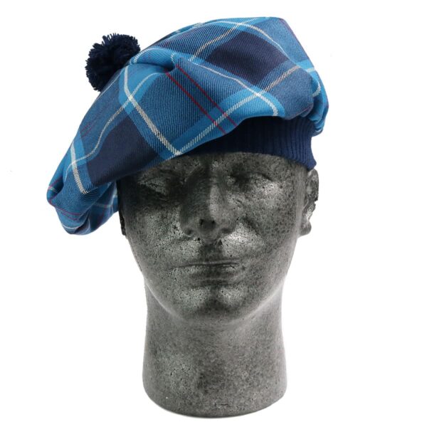 A mannequin wearing a blue tartan beret, paired with the U.S. Marine Corps Premium Light Weight Wool Tam.