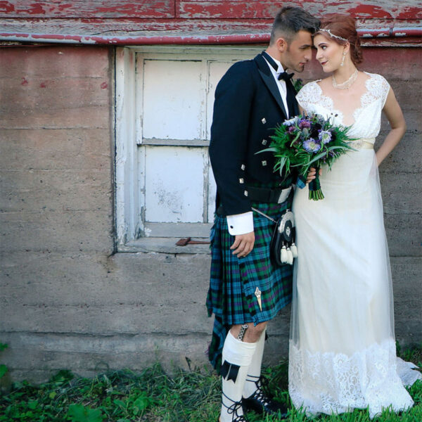 A bride and groom with the Accessories Only Prince Charlie Formal Rental Package, donning kilts.