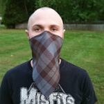 A man wearing a Tartan Bandana Masks - Cotton 80/20.
