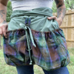 A woman wearing a plaid apron.