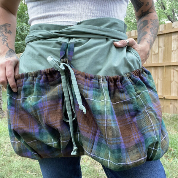 A woman wearing a plaid apron.