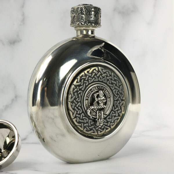 A Clan Crest Antiqued Pewter Flask with a Scottish clan crest emblem on it.