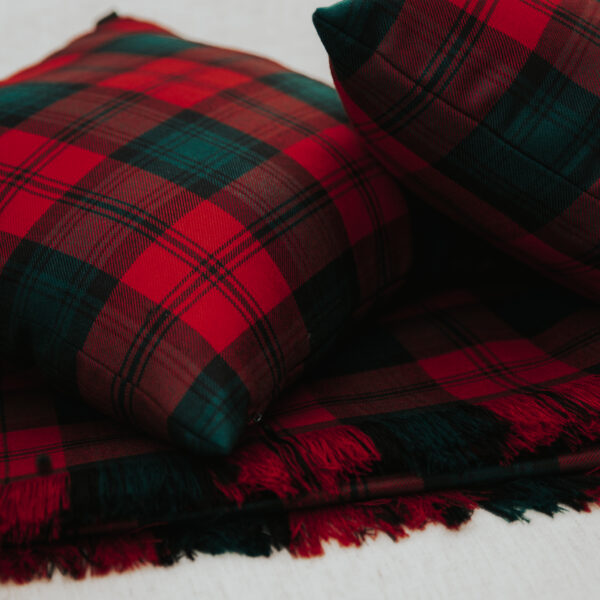 Two red and green plaid Homespun Tartan Blanket/Throw pillows on a white surface.