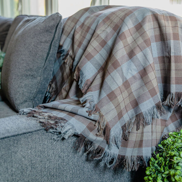 An OUTLANDER Throw/Blanket Authentic Premium Wool Tartan on a couch.