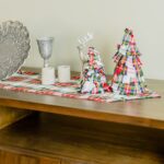 A wooden TV stand adorned with Tartan Christmas Tree - Homespun Wool-Blend decorations.