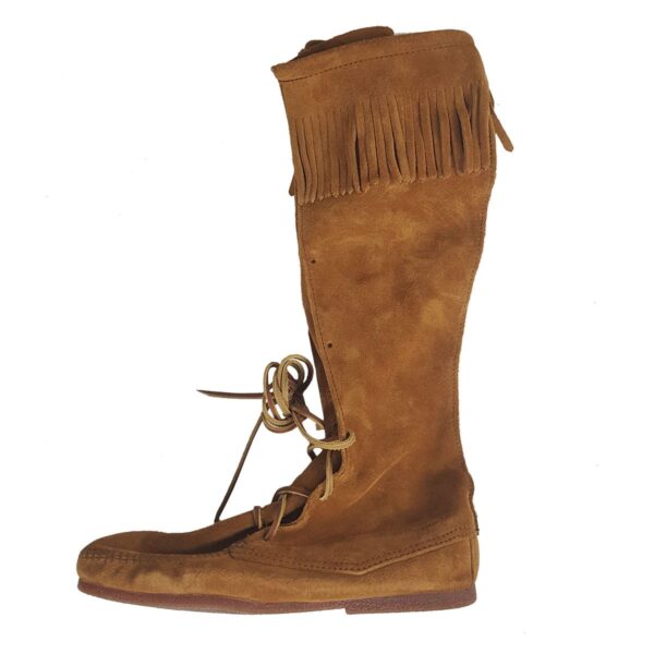 A pair of mens suede knee-high boots with fringes.